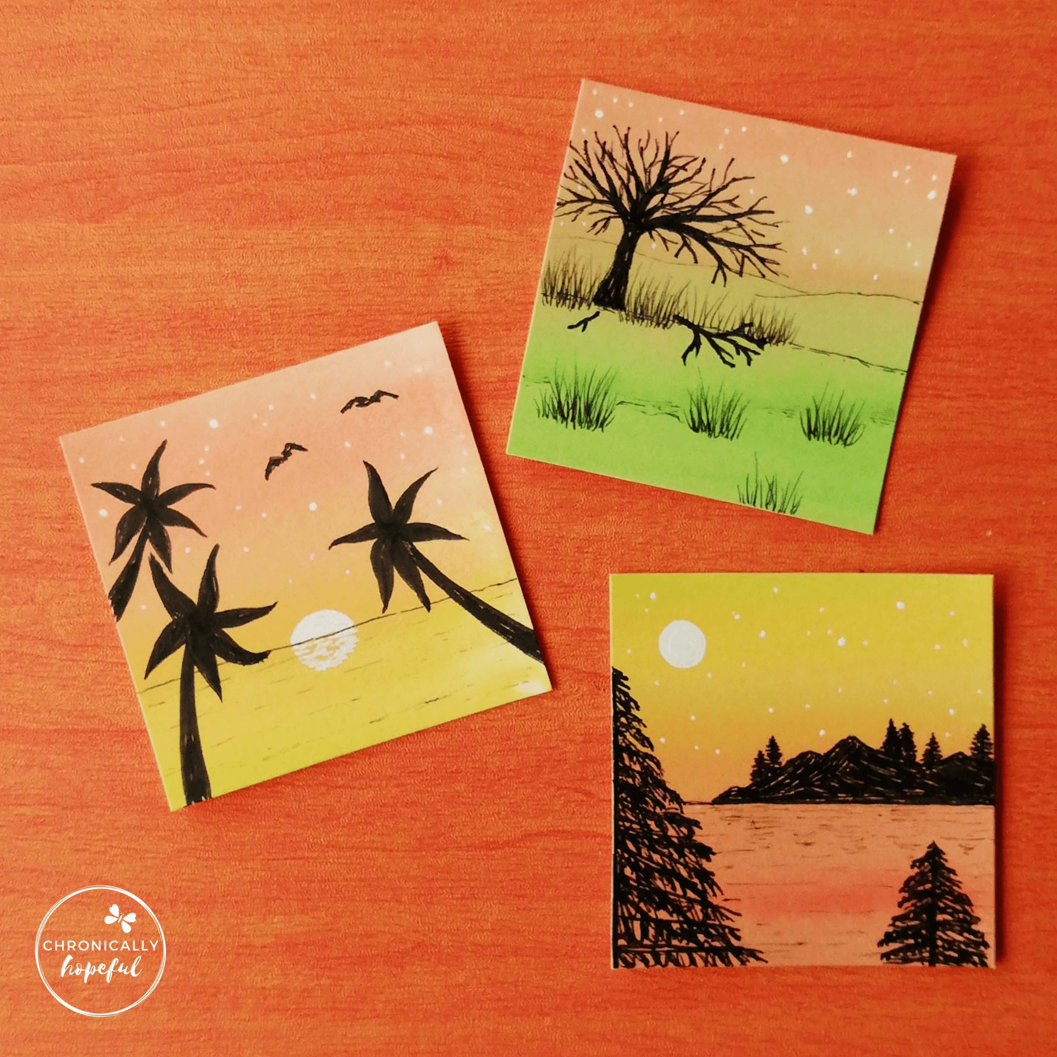 Three 6x6cm mini cards, painted with sunset colours, each with a sunset scene drawn on with black ink.