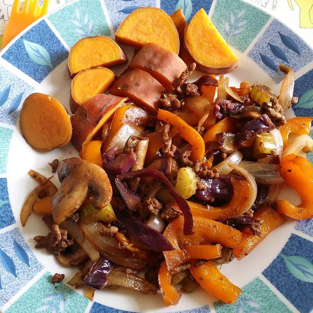 Spicy stir-fry with sweet potato wedges on the side.