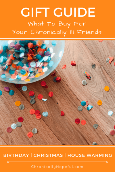 A bowl of colourful confetti spilled on a wooden table. Title says, Gift guide, what to buy for your chronically ill friends.