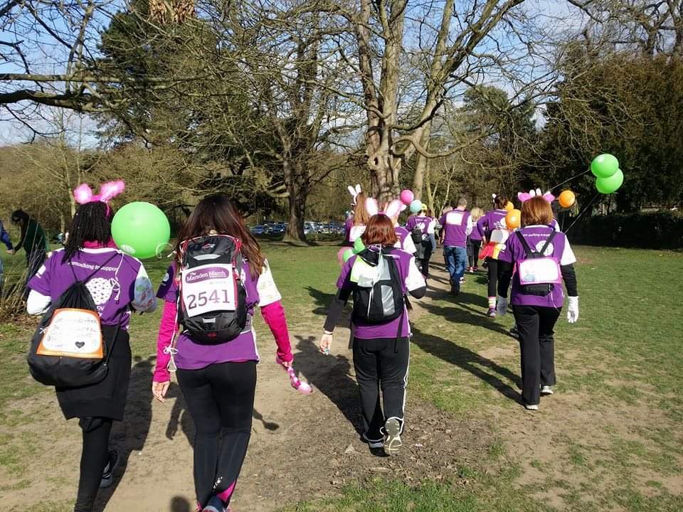 The 5 Bouncing Pink Bunnies, wearing their Marsden March shirts, black leggings and pink bunny ears walking through a field at the Marsden March, Chronically Hopeful
