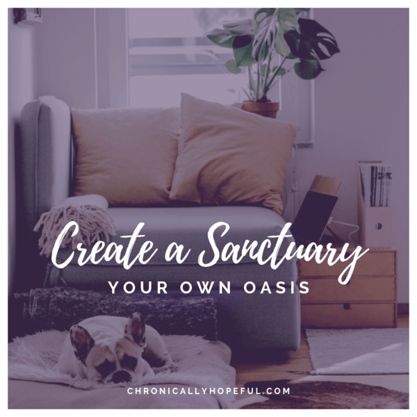 A cosy sofa by a window. With cushions, throw, plant and a puppy on the floor. Quote reads, create a sanctuary, your own oasis.