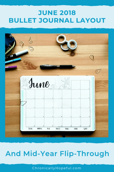 Flatlay of bullet journal open on a table with pents and washi tape above. Title reads June 2018 Bullet Journal layout and mid-year flip through.
