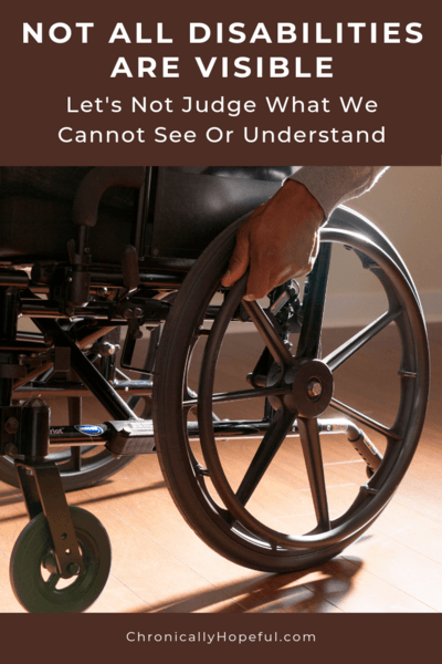 Man in a wheelchair with his hand on the wheel. Title reads: Not all disabilities are visible. Let's not judge what we cannot see or understand.