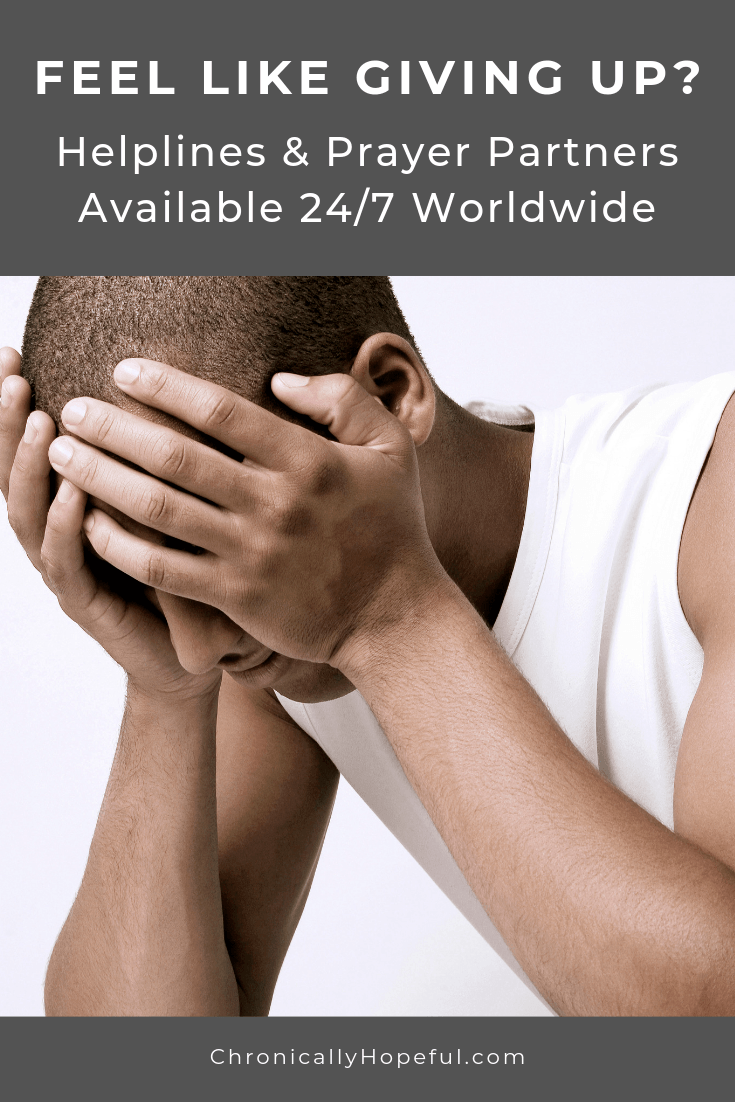 Man holding his head in his hands. Title Reads, Feel like giving up? Helplines & Prayer Partners available 24/7.
